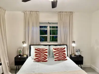 a bedroom with a bed with two red and white pillows at New Brisa Marina in Fort Lauderdale