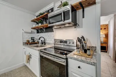 a kitchen with a sink and a stove top oven at Hidden Getaway in Fort Lauderdale
