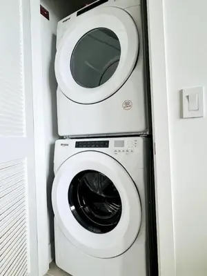a white toilet with a washing machine in a bathroom at 48th Floor PH collection 1 BD Brand New Downtown in Miami