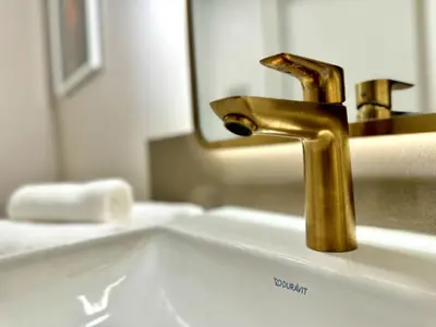 a bathroom sink with a gold faucet on it at 48th Floor PH collection 1 BD Brand New Downtown in Miami