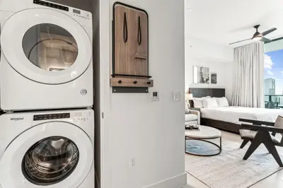 a living room with a washer and dryer in a house at Lux 48th Floor Condo, Water views, Pool, Gym and Spa in Miami