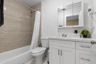 a white bathroom with a toilet and a sink at Miami Japandi Style Pool - BBQ in Miami
