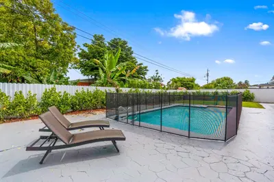 a patio with a chair and a swimming pool at Miami Japandi Style Pool - BBQ in Miami