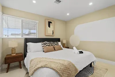 a bedroom with a large bed and a window at Miami Japandi Style Pool - BBQ in Miami