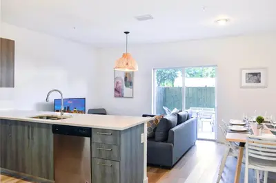 a kitchen and living room with a couch and a table at Entire House with Free Parking at North Miami! in Miami