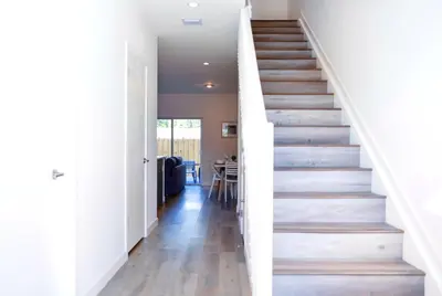 a staircase in a home with white walls and wood floors at Entire House with Free Parking at North Miami! in Miami