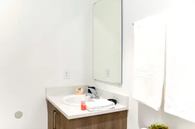 a bathroom with a sink and a mirror at Entire House with Free Parking at North Miami! in Miami