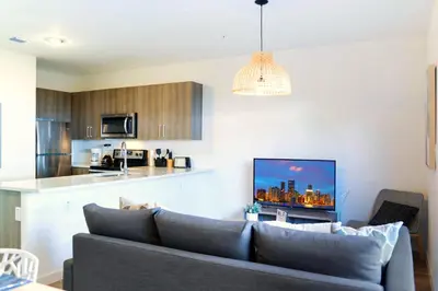a living room with a couch and a kitchen at Entire House with Free Parking at North Miami! in Miami
