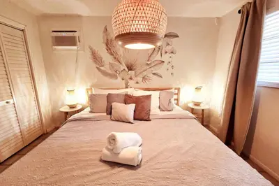 a bedroom with a large bed with towels on it at Hidden Tropical Gem Calle Ocho 1 in Miami