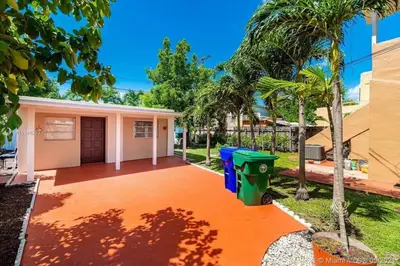 a house with a trash can in a yard at Hidden Tropical Gem Calle Ocho 1 in Miami