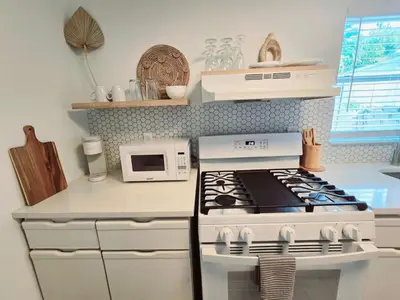 a kitchen with a stove and a microwave at Hidden Tropical Gem Calle Ocho 1 in Miami