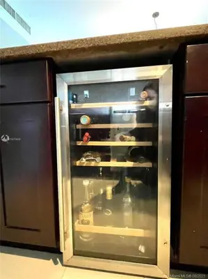 a kitchen with an open oven with a glass door at Spacious 3 BR plus 1 office and 2 BA with Free parking Just in front beach in Sunny Isles Beach