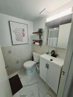 a bathroom with a white toilet and a sink at Cozy Apartment on South Beach in Miami Beach