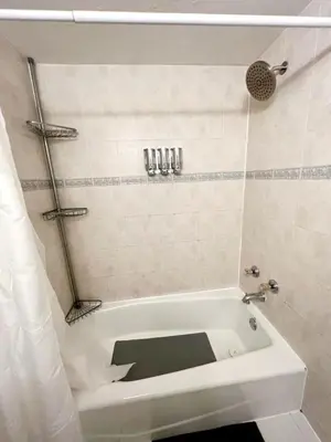 a white bath tub in a bathroom with a shower at Cozy Apartment on South Beach in Miami Beach