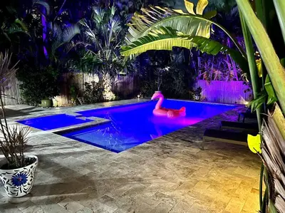 a swimming pool with a pink swan in the water at MIAMI Art Villa Heated Saltwater Pool with SPA EV in Dania Beach