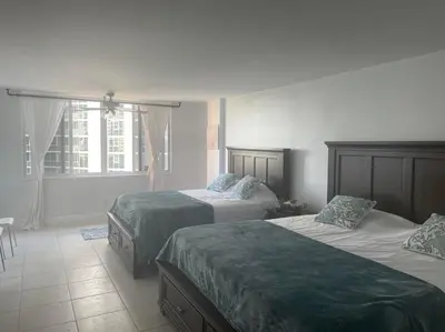 a hotel room with two beds and a window at Beach Escape private studio in Sunny Isles Beach