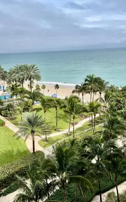 a view of the beach from the balcony of a resort at Beach Escape private studio in Sunny Isles Beach