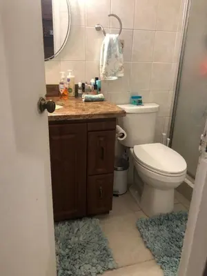 a bathroom with a toilet and a sink and a mirror at Beach Escape private studio in Sunny Isles Beach