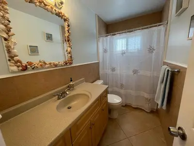 a bathroom with a sink and a toilet and a mirror at Penthouse 2BED2BATH with ocean view & Parking - LaPlaya in Hollywood