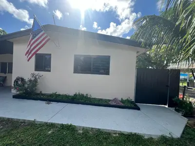 a white house with an american flag on it at Luxury Studio in Miami