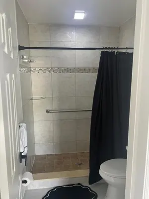 a bathroom with a shower and a toilet at Luxury Studio in Miami