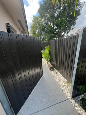 a gate to a fence in front of a house at Luxury Studio in Miami