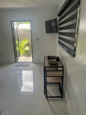 a small desk in a room with a sliding glass door at Luxury Studio in Miami