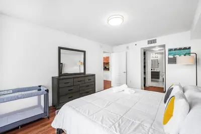 a bedroom with a bed and a dresser and a mirror at Exclusive 1BR Apartment on 35th floor in Miami