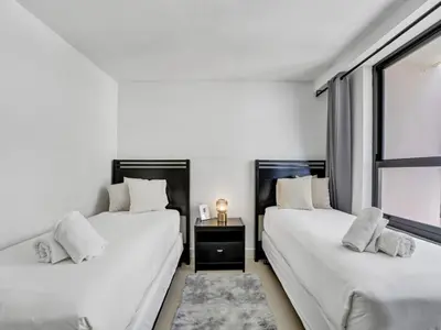 two white beds in a room with a window at Charming Ocean View Condo with Beach Service 1516 in Miami Beach