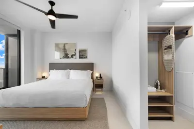 a bedroom with a white bed and a ceiling fan at Stunning Condo with Free Parking on 46th Floor! in Miami