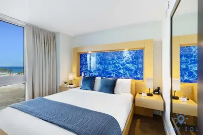 a hotel room with a bed and a window at 1BR Apartment with Ocean View in Sunny Isles Beach