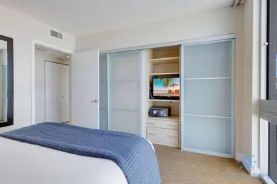 a bedroom with a bed and a tv in it at 1BR Apartment with Ocean View in Sunny Isles Beach
