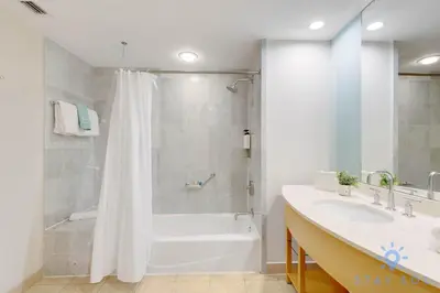 a bathroom with a shower and a tub and a sink at 1BR Apartment with Ocean View in Sunny Isles Beach