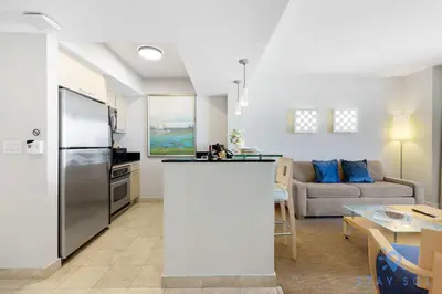 a kitchen and living room with a refrigerator and a couch at 1BR Apartment with Ocean View in Sunny Isles Beach