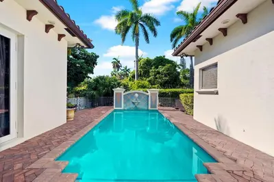 a swimming pool in the backyard of a house at Luxurious 5BR and 3BA Lakefront Villa near Beach in Hollywood