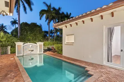 a swimming pool in the backyard of a house at Luxurious 5BR and 3BA Lakefront Villa near Beach in Hollywood