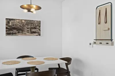 a dining room with a white table and chairs at 48Flr Condo w Free Parking in Miami