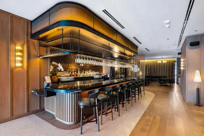 a bar in a restaurant with stools at 48Flr Condo w Free Parking in Miami