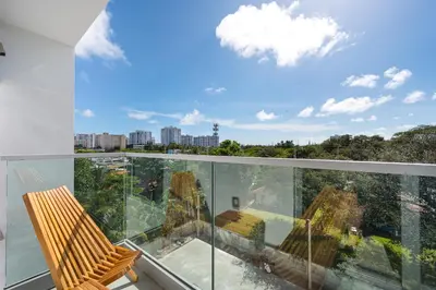 a balcony with a chair and a view of the city at Milan Aventura Hotel in Aventura