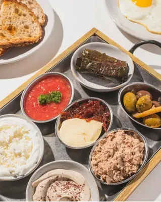 a tray of different types of food on a table at Milan Aventura Hotel in Aventura