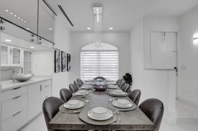 a dining room with a table and chairs in a kitchen at 4 BR Designer Home Next to Shul and Community Pool villa in Fort Lauderdale