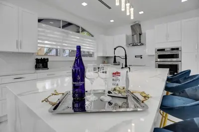 a blue bottle sitting on a counter in a kitchen at 4 BR Designer Home Next to Shul and Community Pool villa in Fort Lauderdale