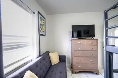 a living room with a couch and a dresser at Tropical Retreat in Miami Beach in North Miami Beach