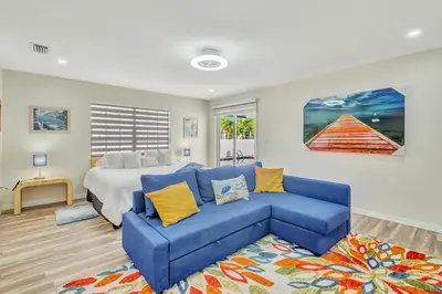 a bedroom with a bed and a blue couch at Dreams Studio in Hialeah