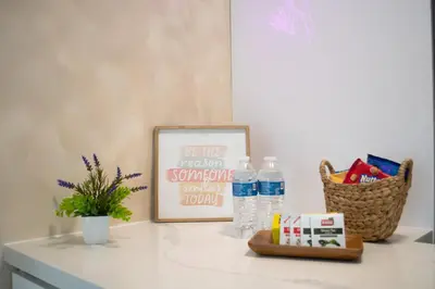 a counter with a picture and water bottles on it at Villa Roads - Ideal Stay in Miami - King - Bed Parking - Near Airport, Brickell, Coconut Grove, Little Havana, Wynwood & Calle 8 in Miami