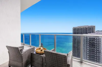 a balcony with chairs and a view of the ocean at 2BR Ocean View Balcony & Pool in Hollywood