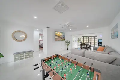 a living room with a pool table in the middle of it at Home with Games Pool Paradise in Fort Lauderdale
