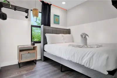 a bedroom with a large bed and a window at Stylish Miami Suites with Self Check-in in Miami