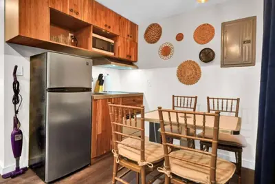 a kitchen with a stainless steel refrigerator and wooden cabinets at Stylish Miami Suites with Self Check-in in Miami