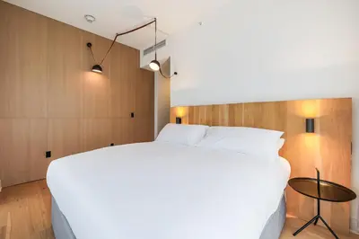 a bedroom with a white bed and a table at The March Hotel in Miami Beach
